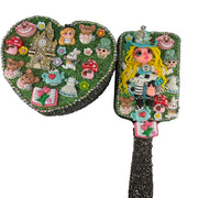 close up of decorated hairbrush and heart jewelry box with teapots and flex porcelain details