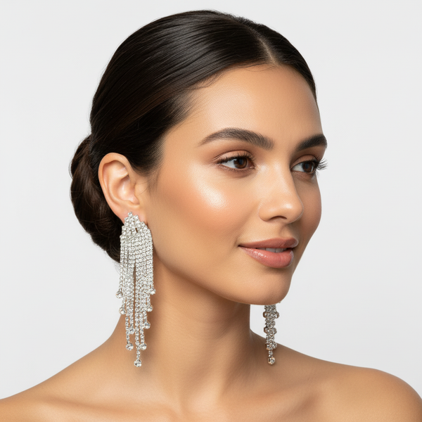 Elegant model showcasing the silver-tone crystal teardrop earrings, demonstrating the cascading sparkle and sophisticated scale of the dangle jewelry for formal events
