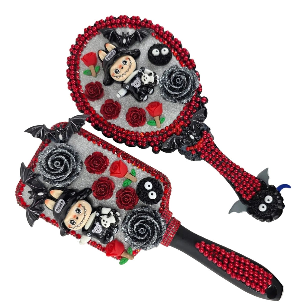 detail of gothic hand mirrors with red flat back rhinestones, black roses and monster figures