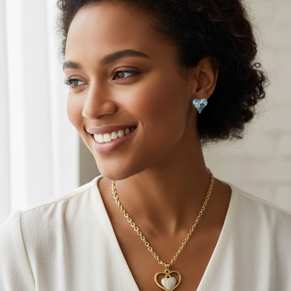 Diverse model wearing the gold-tone heart pendant necklace and matching crystal heart earrings