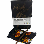 Notebook with marble design, pen, and socks on a white background