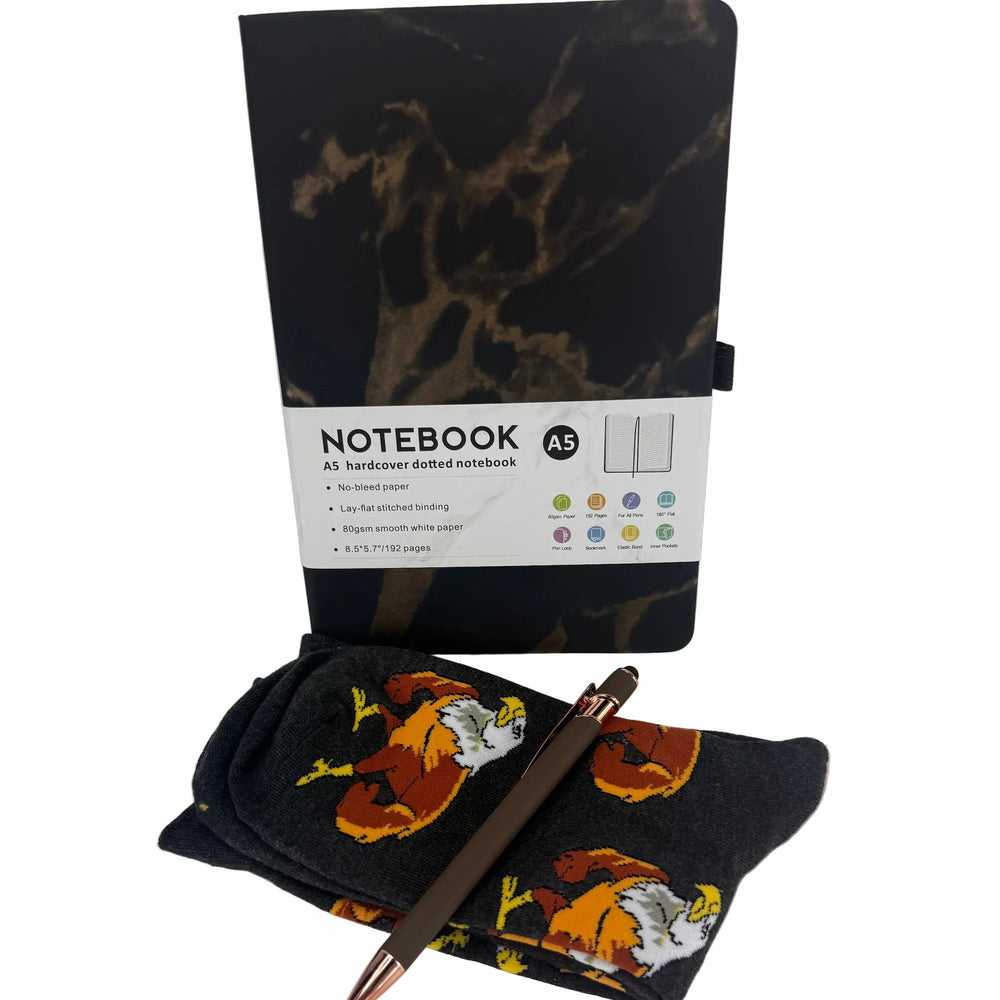 Notebook with marble design, pen, and socks on a white background