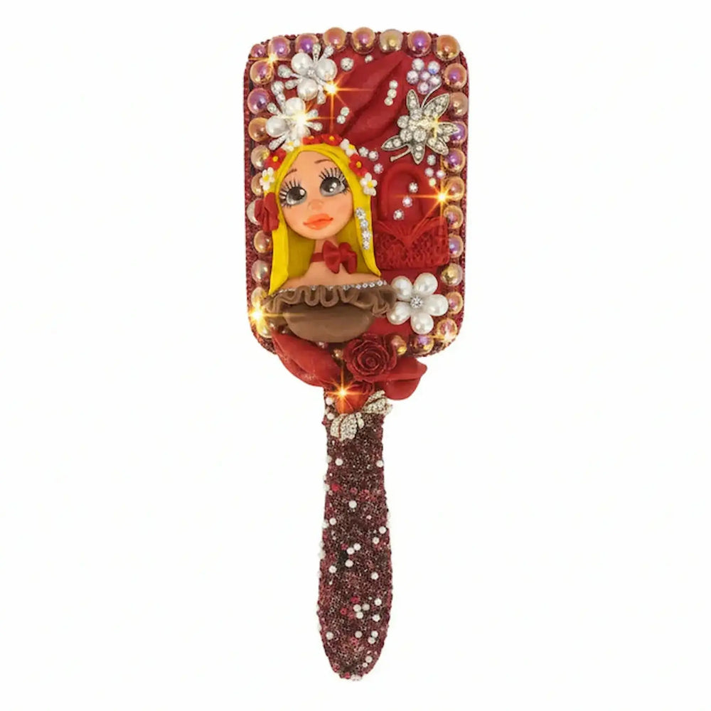 hair brush decorated with handcrafted porcelain doll and colorful charms