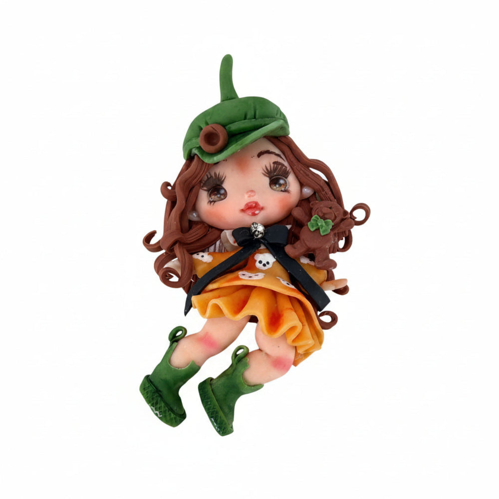 handmade Paris doll with curly brown hair, green beret hat, yellow dress, and green boots, 9cm flatback charm
