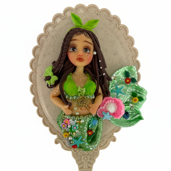 handmade cold porcelain mermaid doll applique displayed next mirror 