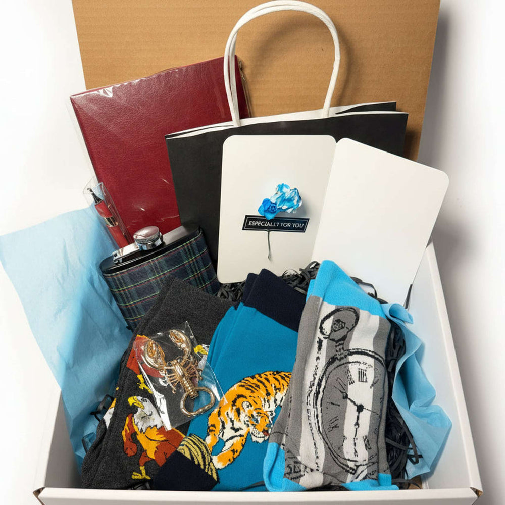 Hand-curated luxury men's gift box featuring a plaid flask, executive notebook, and handcrafted exotic woman bust keychain from Majestic Boutique.