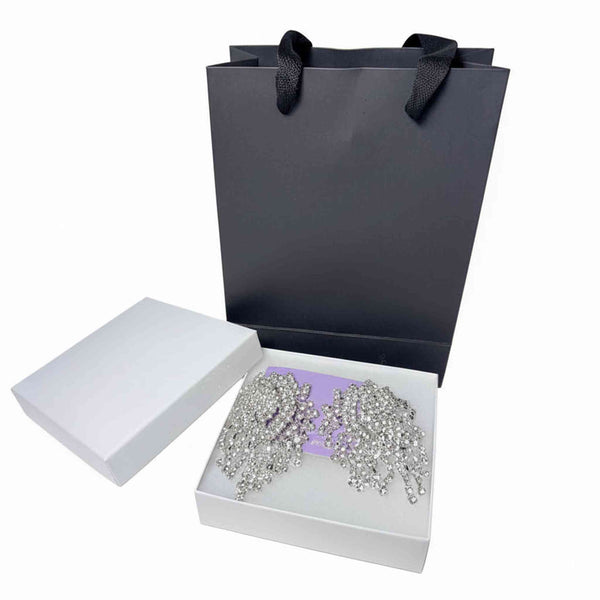 luxury rhinestone dangle earrings with cascading crystal design and elegant black paper bag