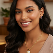 Diverse model wearing the gold-tone crystal heart necklace and matching heart earrings.