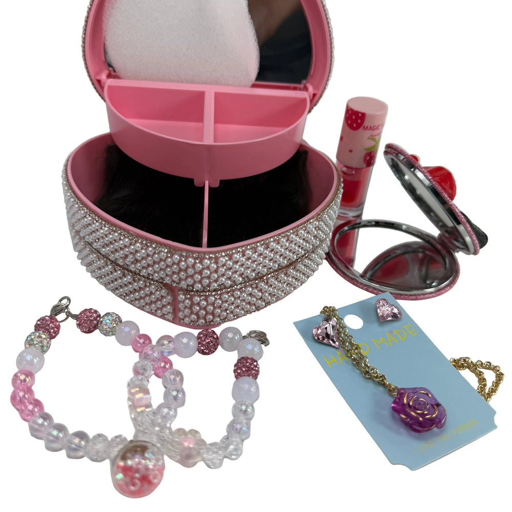 open pink heart jewelry box showing its interior compartments for storing rings and fashion accessories