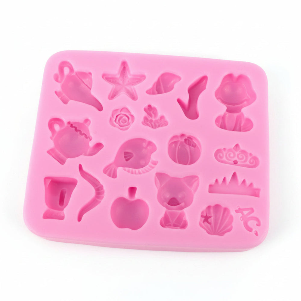pink silicone mold for jewelry making with multiple small cavities including nature-inspired motifs like pumpkins and sea-themed shapes