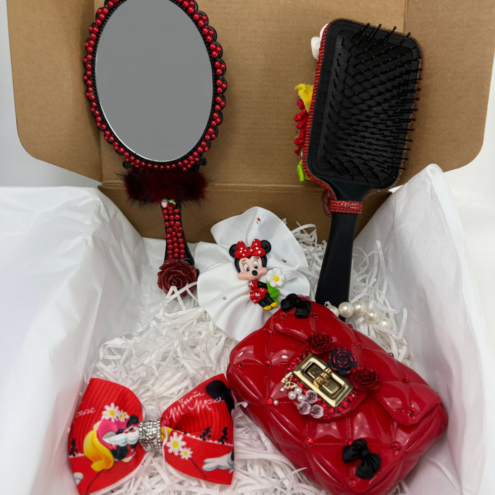 rich red small purse with cute charms next to a handmade white hair bow with a clay character and a red cartoon bow