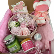 rose spa gift basket with essential oil candle, bath bombs, exfoliating scrub, and cute bear towel