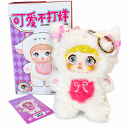 side view of nommi nene plush featuring sparkling yellow crystals, large gray eyes, pink belly patch, box, and card.