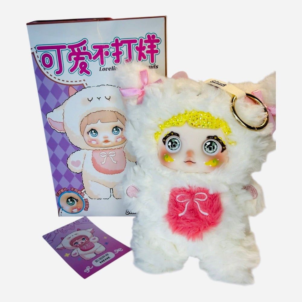side view of pink nommi mimi plush with crystal bedazzled details and box
