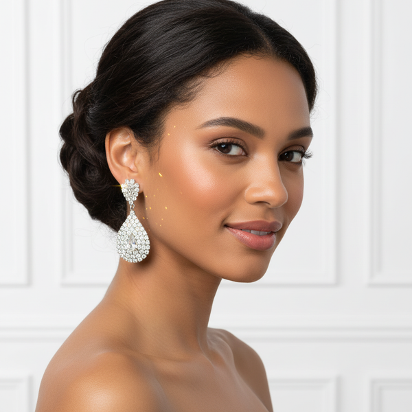 Elegant model wearing silver-tone crystal teardrop earrings, showcasing the sophisticated dangle style and sparkling scale for weddings and formal occasions