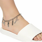 silver-tone hairdresser charm anklet with scissors and comb pendants on a model's ankle