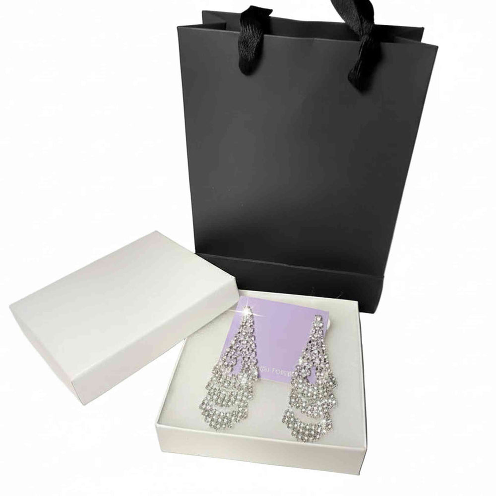 silver rhinestone dangle earrings displayed with premium white gift box and black paper bag