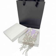 silver rhinestone drop earrings presented in a white jewelry box 