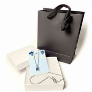 silver tone cat pendant necklace and blue heart crystal earrings 
