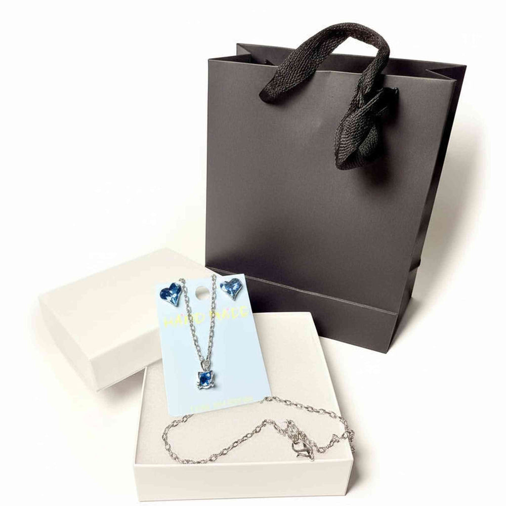 silver tone cat pendant necklace and blue heart crystal earrings 
