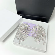 Close-up of sparkling rhinestone fringe earrings with a brilliant cascading design for weddings and formal events
