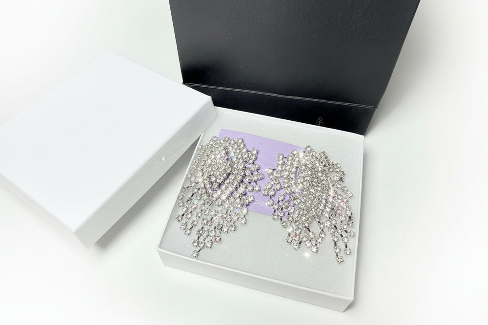 Close-up of sparkling rhinestone fringe earrings with a brilliant cascading design for weddings and formal events