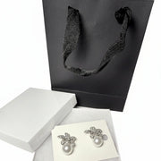 sparkly floral earrings with pearls and black gift bag