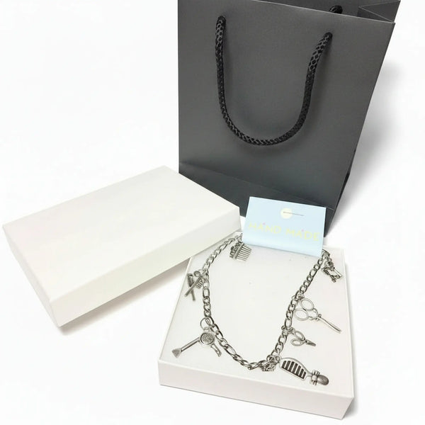 stylist charm anklet with silver-tone pendants in a luxury white gift box.