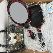 top view of gothic gift box with mirror, brush, small purse and bows 