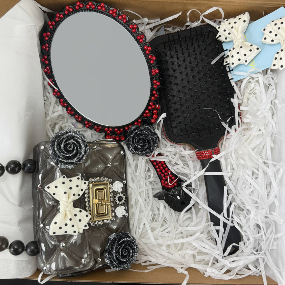 top view of gothic gift box with mirror, brush, small purse and bows 