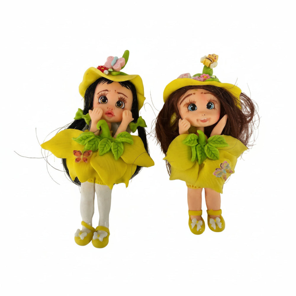 two dolls in yellow outfits with floral hats, flex porcelain dolls